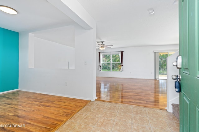 unfurnished room with ceiling fan, a healthy amount of sunlight, and light wood-type flooring