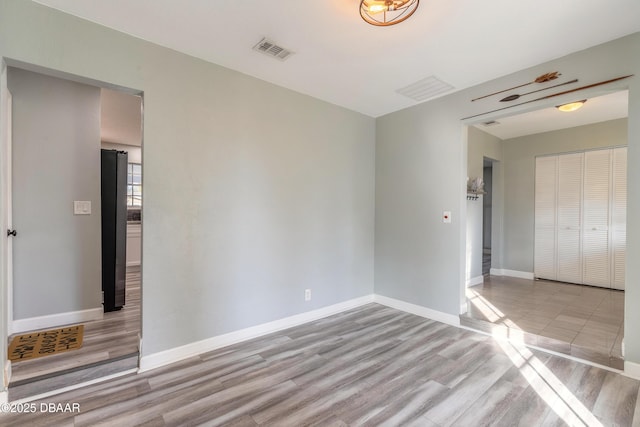 spare room with light wood-type flooring