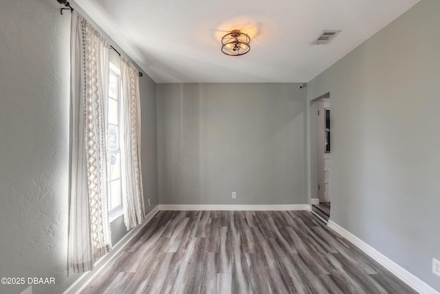 spare room with wood-type flooring