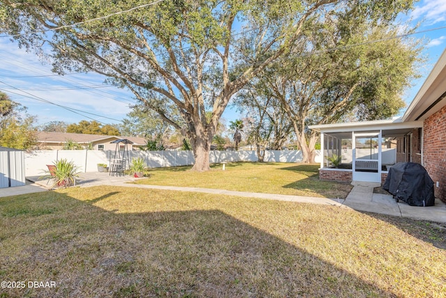 view of yard featuring a patio and a sunroom