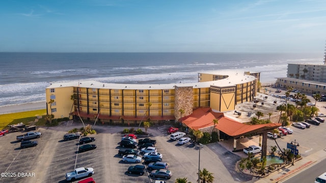 bird's eye view featuring a water view and a beach view