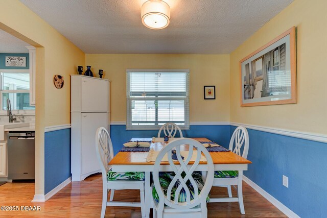 948 Northbrook Dr, Ormond Beach, FL 32174 - dining room featuring light wood-style floors and a textured ceiling