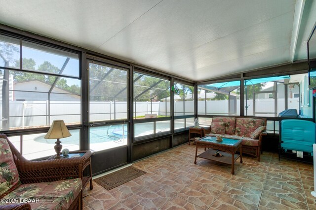 948 Northbrook Dr, Ormond Beach, FL 32174 - sunroom / solarium with plenty of natural light, lofted ceiling, and an outdoor living space