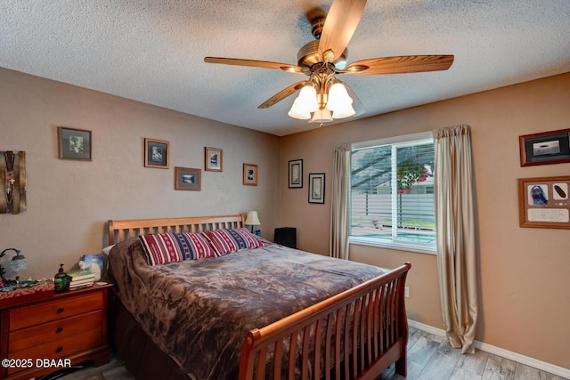 948 Northbrook Dr, Ormond Beach, FL 32174 - bedroom featuring a textured ceiling, light wood-style floors, and ceiling fan