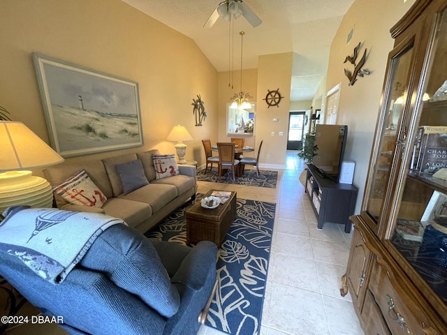 tiled living room featuring ceiling fan and lofted ceiling