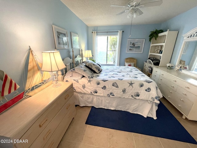 tiled bedroom with a textured ceiling and ceiling fan