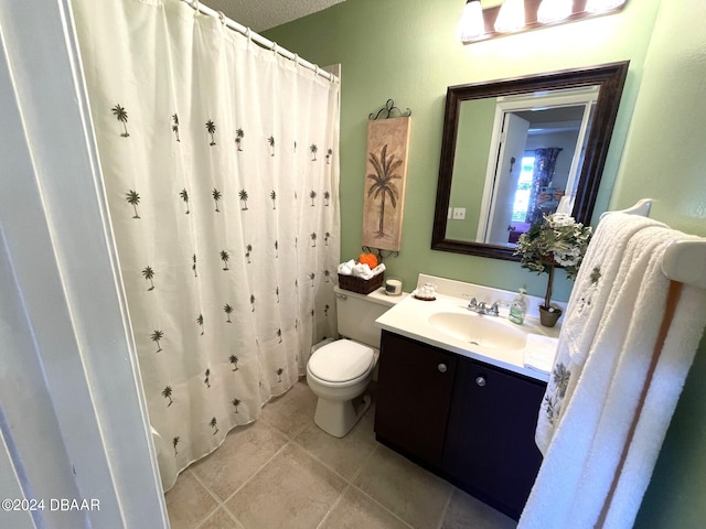 bathroom with a shower with curtain, a textured ceiling, vanity, tile patterned floors, and toilet