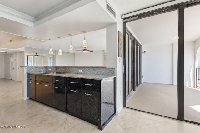 3003 S Atlantic Ave Unit 16B3, Daytona Beach Shores, FL 32118 - kitchen with a ceiling fan, light tile patterned floors, hanging light fixtures, and light stone countertops