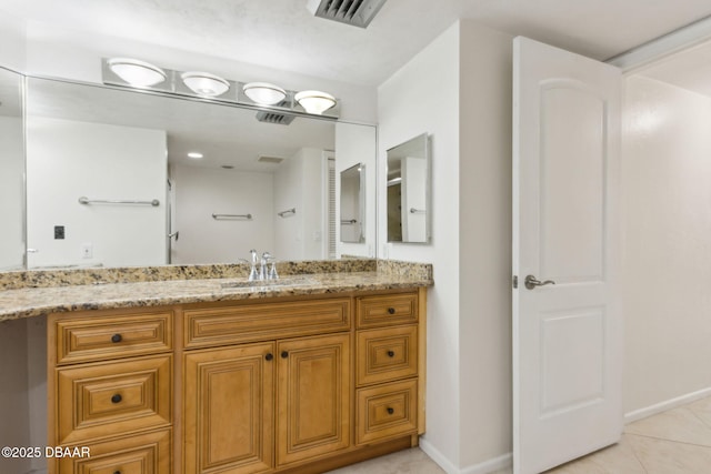 3003 S Atlantic Ave Unit 16B3, Daytona Beach Shores, FL 32118 - bathroom featuring tile patterned flooring, vanity, and baseboards