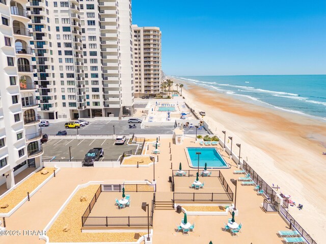 drone / aerial view of apartment complex / building and extended coastline