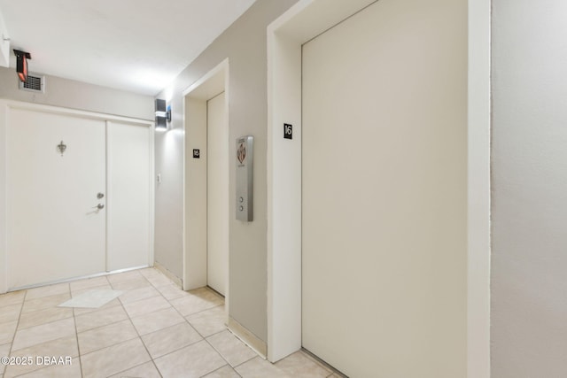 3003 S Atlantic Ave Unit 16B3, Daytona Beach Shores, FL 32118 - hall with light tile patterned flooring and elevator