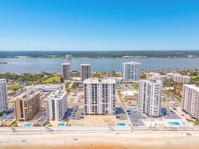 view of urban area featuring a large body of water and a pool