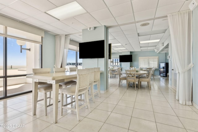 3003 S Atlantic Ave Unit 16B3, Daytona Beach Shores, FL 32118 - dining area featuring a drop ceiling and light tile patterned floors