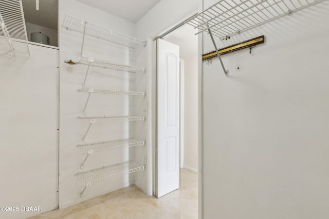 3003 S Atlantic Ave Unit 16B3, Daytona Beach Shores, FL 32118 - walk in closet featuring tile patterned floors