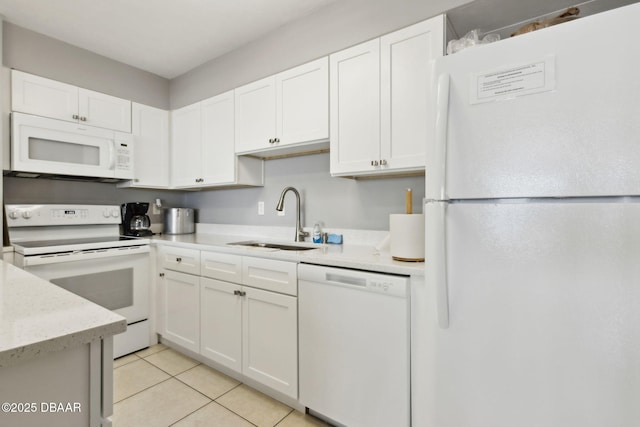 3003 S Atlantic Ave Unit 16B3, Daytona Beach Shores, FL 32118 - kitchen featuring white appliances, a sink, white cabinets, and light tile patterned floors