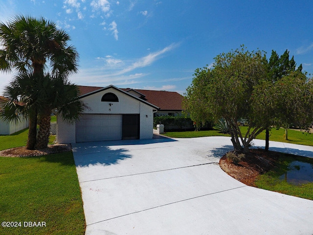 single story home featuring a front lawn and a garage