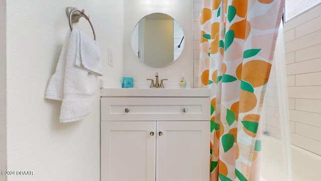 bathroom with shower / bath combo with shower curtain and vanity