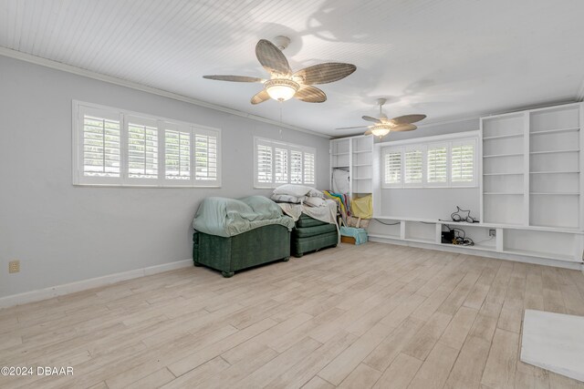 801 E 24th Ave, New Smyrna Beach, FL 32169 - living area with healthy amount of natural light, ceiling fan, wood finished floors, ornamental molding, and baseboards