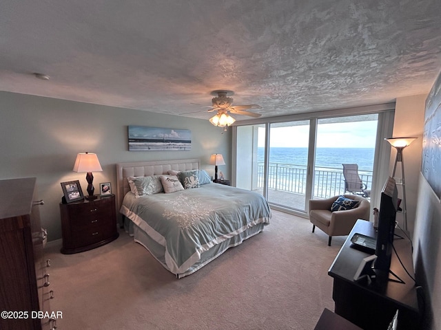 bedroom featuring carpet flooring, ceiling fan, a textured ceiling, and access to outside