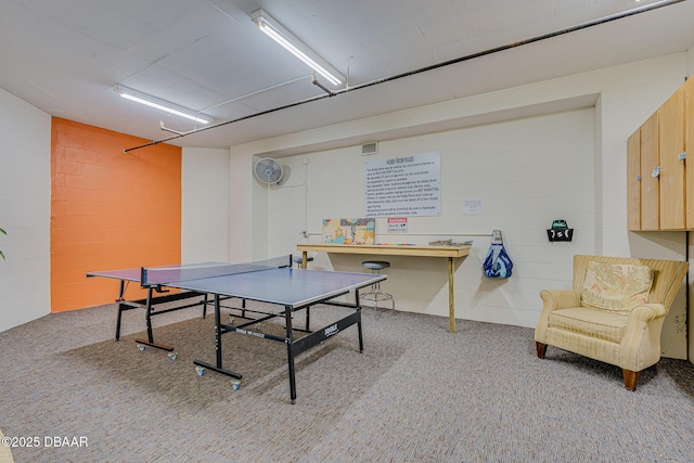 playroom featuring concrete block wall