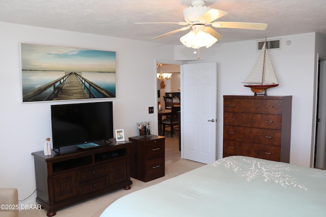 bedroom with light carpet, ceiling fan with notable chandelier, and visible vents