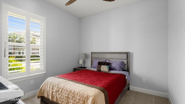 bedroom featuring carpet flooring, multiple windows, and ceiling fan