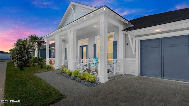 exterior space featuring a garage and covered porch