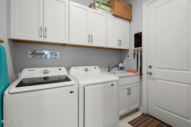 laundry room with cabinets, sink, independent washer and dryer, and light tile patterned floors