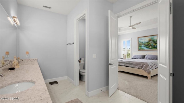 bathroom featuring ceiling fan, vanity, and toilet