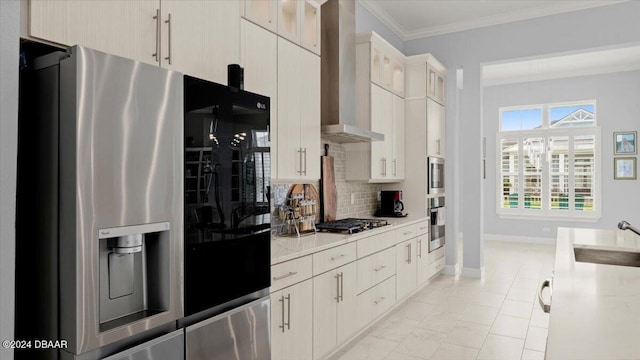 kitchen with stainless steel appliances, sink, backsplash, crown molding, and wall chimney range hood