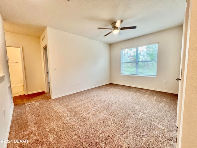 carpeted empty room featuring ceiling fan