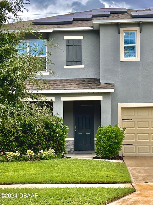 view of front facade featuring a garage and a front yard