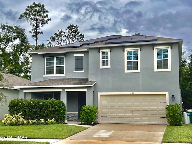 view of front facade featuring solar panels, a front yard, and a garage