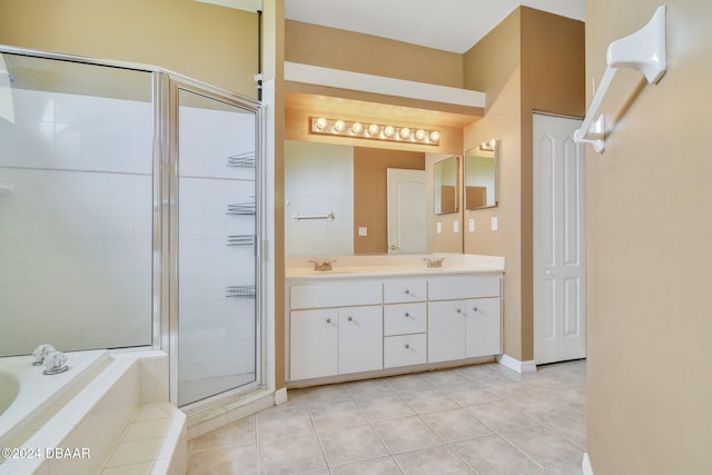 5976 Sawgrass Point Dr, Port Orange, FL 32128 - bathroom featuring a garden tub, double vanity, tile patterned floors, and a stall shower