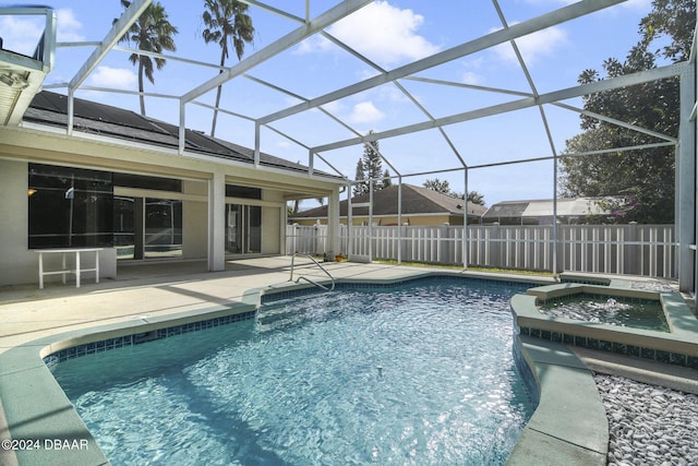 view of pool featuring a lanai, an in ground hot tub, and a patio