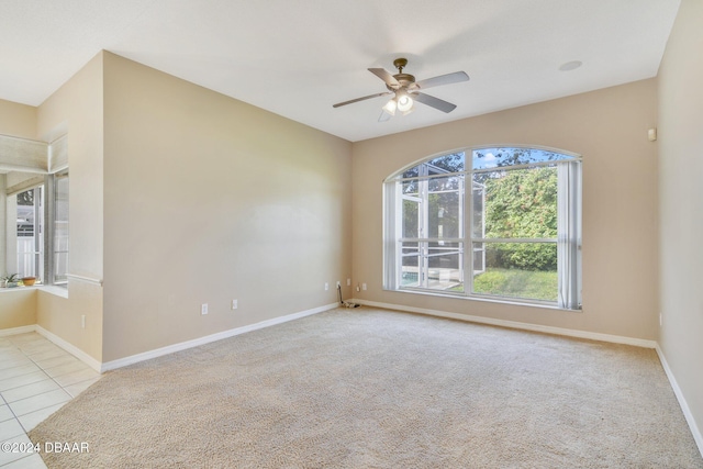 spare room with light carpet and ceiling fan