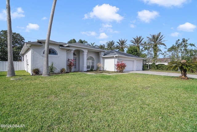 ranch-style house featuring a front yard and a garage