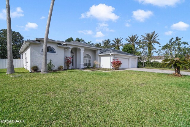 5976 Sawgrass Point Dr, Port Orange, FL 32128 - ranch-style house featuring concrete driveway, a garage, and stucco siding