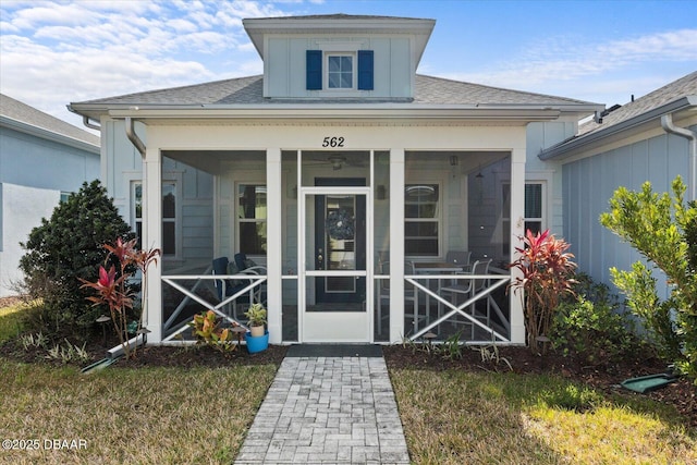 view of exterior entry with a yard