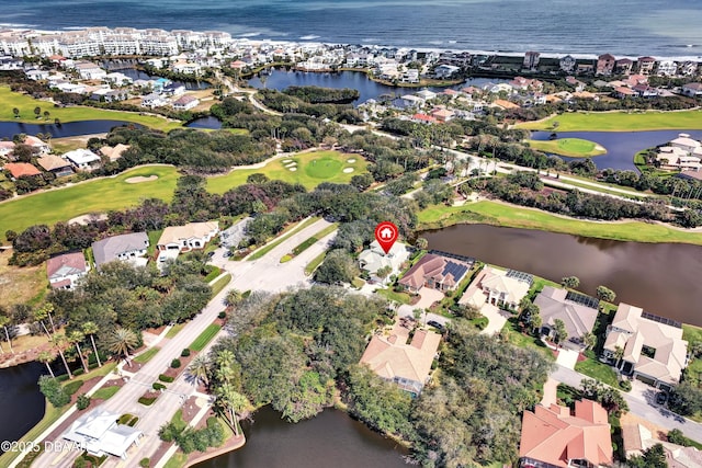 birds eye view of property featuring a water view, view of golf course, and a residential view