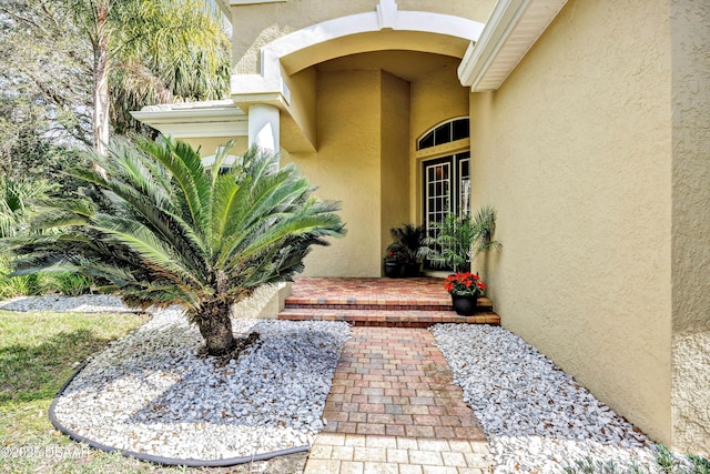 property entrance with stucco siding