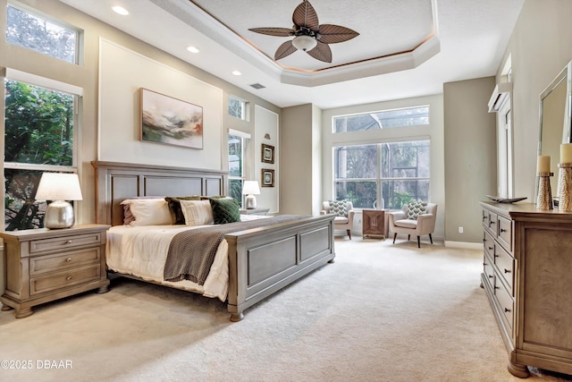 bedroom with recessed lighting, a raised ceiling, visible vents, light carpet, and baseboards