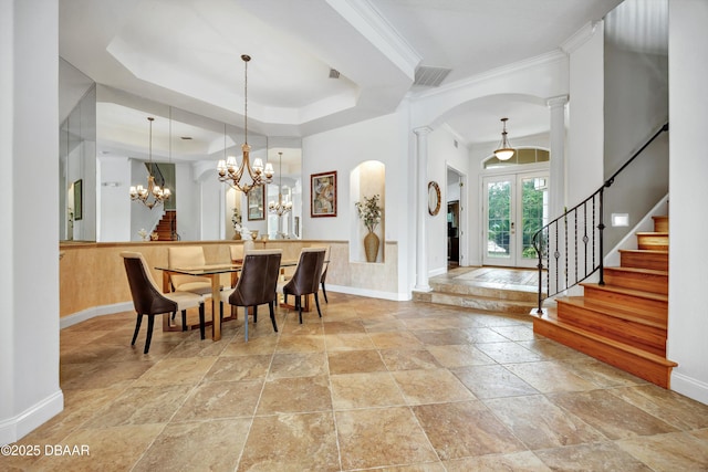 dining area featuring a chandelier, visible vents, french doors, stairway, and a raised ceiling