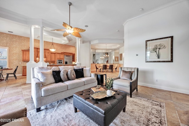 living area featuring crown molding, decorative columns, and baseboards