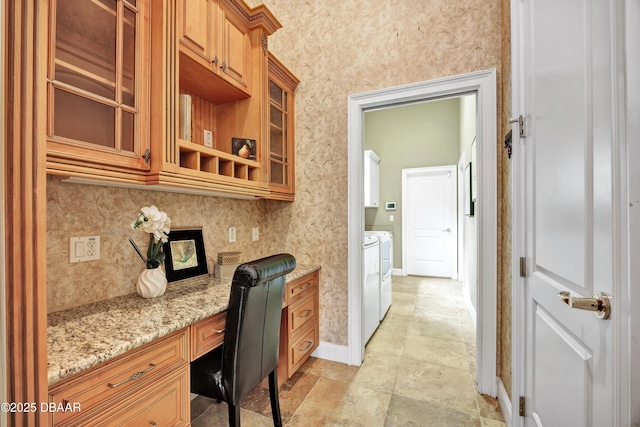 home office with washing machine and dryer, built in study area, and baseboards