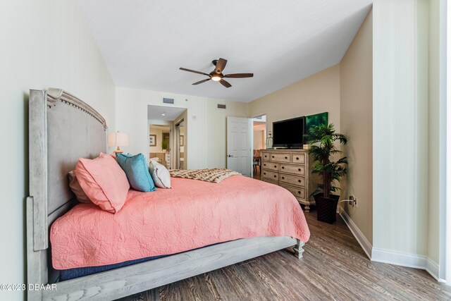 231 Riverside Dr Unit 1806, Holly Hill, FL 32117 - bedroom featuring wood finished floors, ensuite bath, and a ceiling fan
