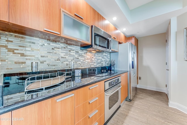 231 Riverside Dr Unit 1806, Holly Hill, FL 32117 - kitchen with appliances with stainless steel finishes, modern cabinets, dark stone countertops, light wood-style flooring, and decorative backsplash