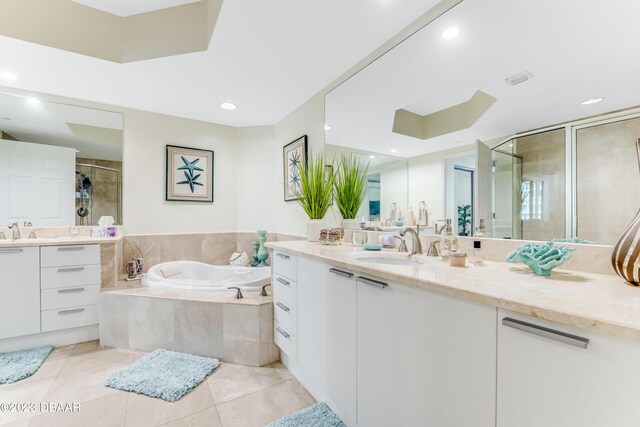 231 Riverside Dr Unit 1806, Holly Hill, FL 32117 - bathroom featuring a stall shower, two vanities, a garden tub, tile patterned floors, and recessed lighting