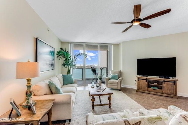 231 Riverside Dr Unit 1806, Holly Hill, FL 32117 - living area featuring a ceiling fan, wood finished floors, and a wall of windows