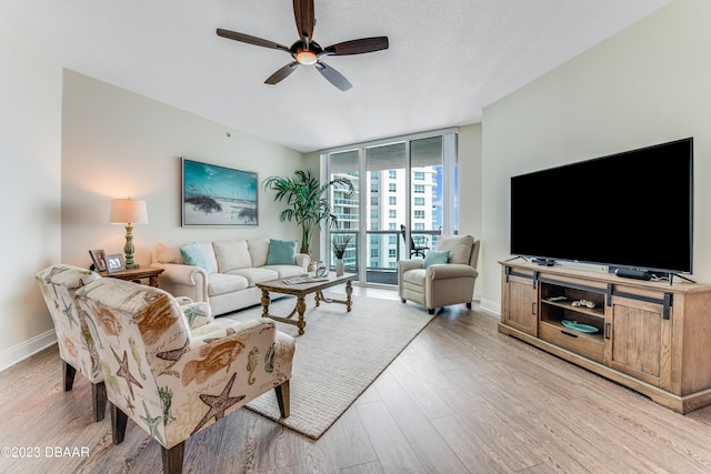 231 Riverside Dr Unit 1806, Holly Hill, FL 32117 - living room with a ceiling fan, expansive windows, and light wood finished floors